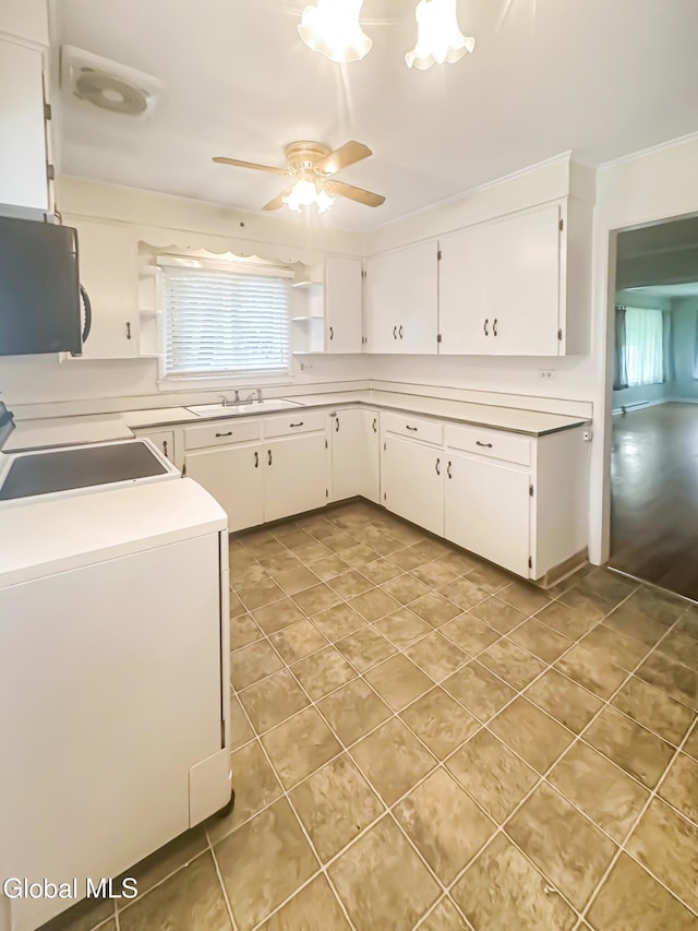 32 Abeling St, Canajoharie, NY 13317 - kitchen with light tile patterned floors, ceiling fan, light countertops, and white cabinets