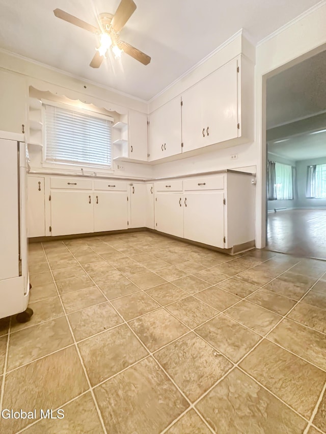 32 Abeling St, Canajoharie, NY 13317 - kitchen featuring light tile patterned floors, ornamental molding, white cabinetry, ceiling fan, and light countertops