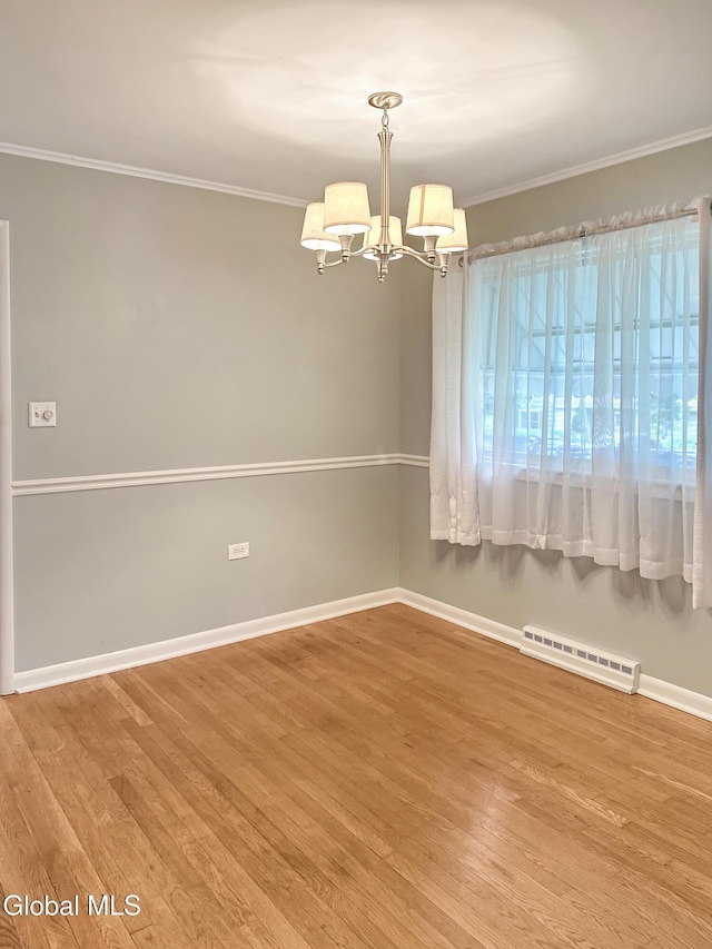 32 Abeling St, Canajoharie, NY 13317 - unfurnished room featuring crown molding, a chandelier, and wood finished floors