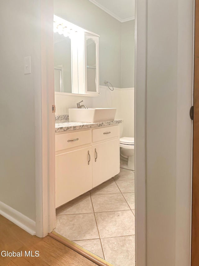 32 Abeling St, Canajoharie, NY 13317 - bathroom featuring ornamental molding, vanity, tile patterned floors, and a wainscoted wall