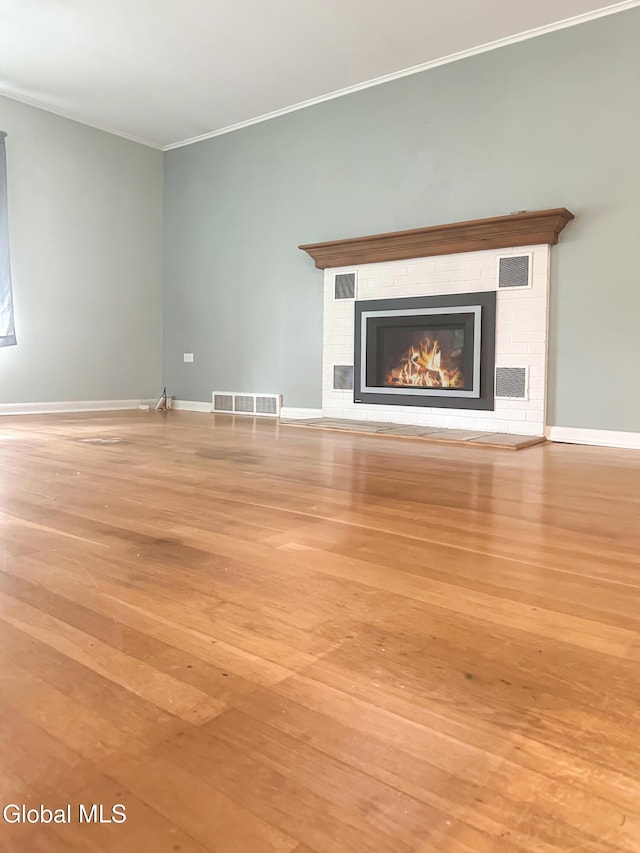 32 Abeling St, Canajoharie, NY 13317 - unfurnished living room with hardwood / wood-style flooring, ornamental molding, and a fireplace