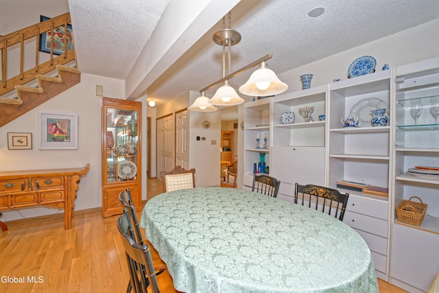 35 Warwick Way, Niskayuna, NY 12309 - dining area featuring a textured ceiling, light wood-type flooring, and stairway