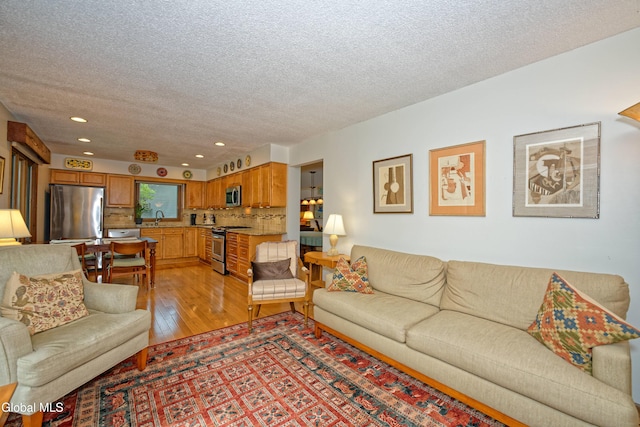 35 Warwick Way, Niskayuna, NY 12309 - living room featuring light wood-style floors, a textured ceiling, and recessed lighting