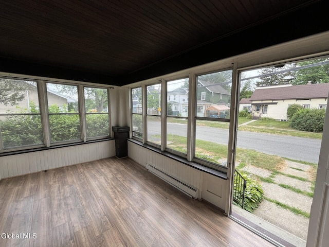 1822 7th St, Rensselaer, NY 12144 - unfurnished sunroom featuring baseboard heating, wood finished floors, and plenty of natural light