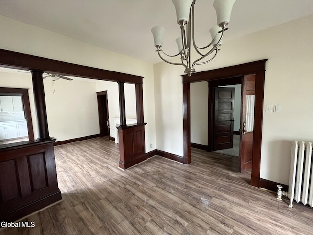 1822 7th St, Rensselaer, NY 12144 - unfurnished room with radiator, a chandelier, dark wood-type flooring, and a ceiling fan