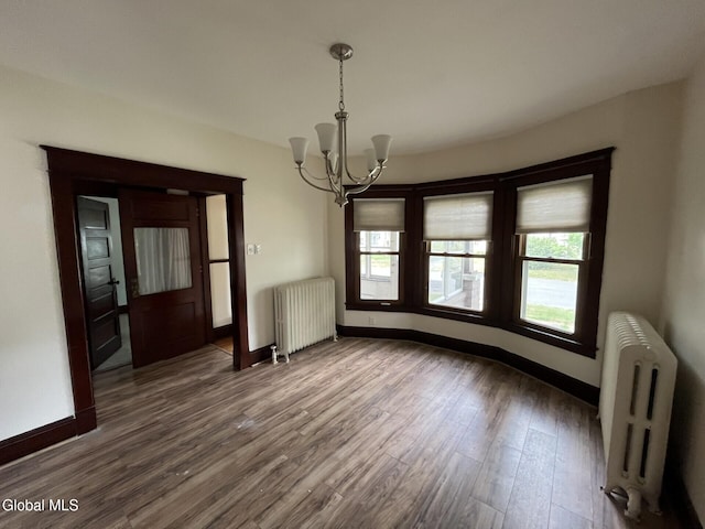 1822 7th St, Rensselaer, NY 12144 - unfurnished dining area with radiator heating unit, a chandelier, and healthy amount of natural light