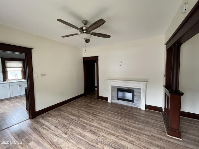 1822 7th St, Rensselaer, NY 12144 - unfurnished living room featuring a high end fireplace, wood finished floors, and ceiling fan