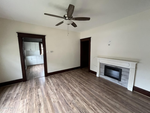 1822 7th St, Rensselaer, NY 12144 - unfurnished living room featuring wood finished floors, a ceiling fan, and a glass covered fireplace