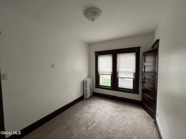 1822 7th St, Rensselaer, NY 12144 - unfurnished room with radiator heating unit and carpet flooring