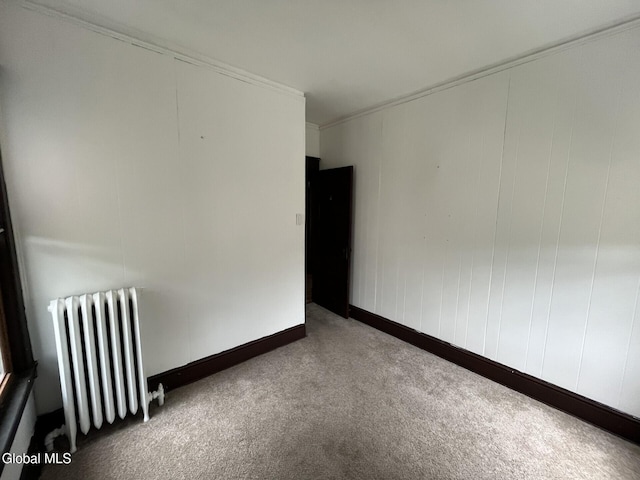 1822 7th St, Rensselaer, NY 12144 - spare room featuring radiator heating unit, carpet, and ornamental molding