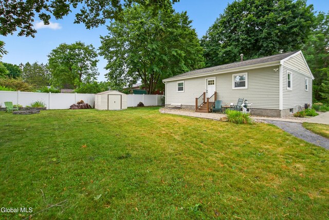 55 Crescent Ave, Saratoga Springs, NY 12866 - rear view of house with entry steps, a fenced backyard, and a shed