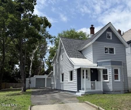 1338 Crane St, Schenectady, NY 12303 - view of front of property with a chimney and a front lawn