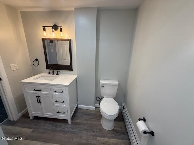 1338 Crane St, Schenectady, NY 12303 - bathroom with wood finished floors, vanity, and a baseboard radiator