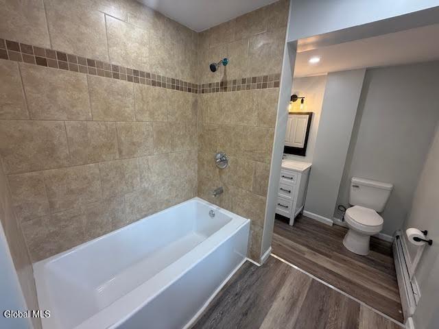 1338 Crane St, Schenectady, NY 12303 - full bathroom featuring wood finished floors, vanity,  shower combination, and a baseboard heating unit