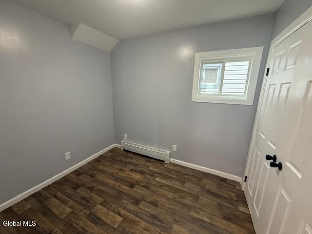 1338 Crane St, Schenectady, NY 12303 - empty room featuring dark wood-style floors and a baseboard radiator
