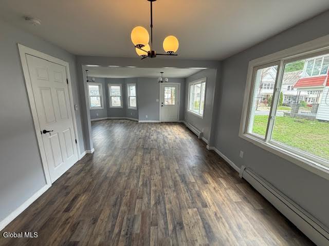 1338 Crane St, Schenectady, NY 12303 - unfurnished living room featuring a baseboard radiator, a chandelier, and dark wood finished floors