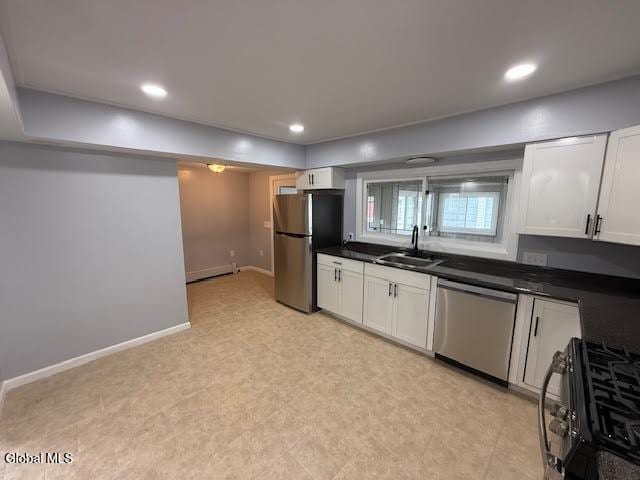 1338 Crane St, Schenectady, NY 12303 - kitchen featuring stainless steel appliances, dark countertops, white cabinets, and recessed lighting