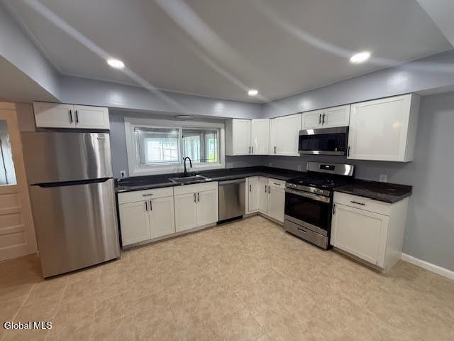 1338 Crane St, Schenectady, NY 12303 - kitchen with stainless steel appliances, white cabinetry, dark countertops, and recessed lighting