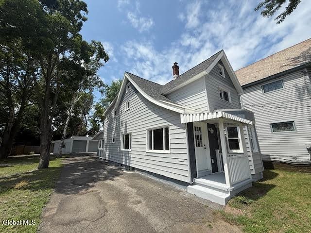 1338 Crane St, Schenectady, NY 12303 - view of front of property featuring a chimney, driveway, and a front lawn