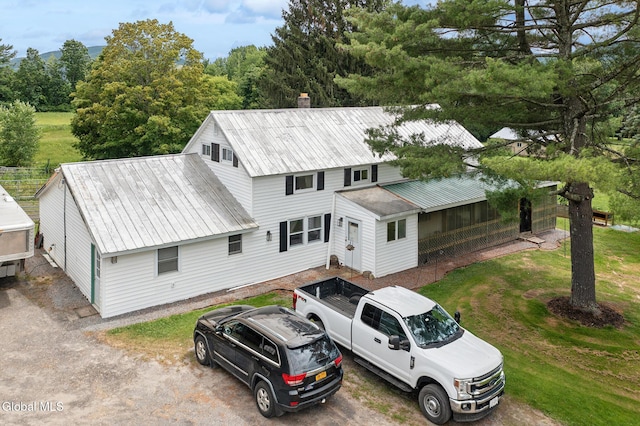 420 Caverns Rd, Cobleskill, NY 12092 - view of front of house featuring a metal roof, a front lawn, and a chimney