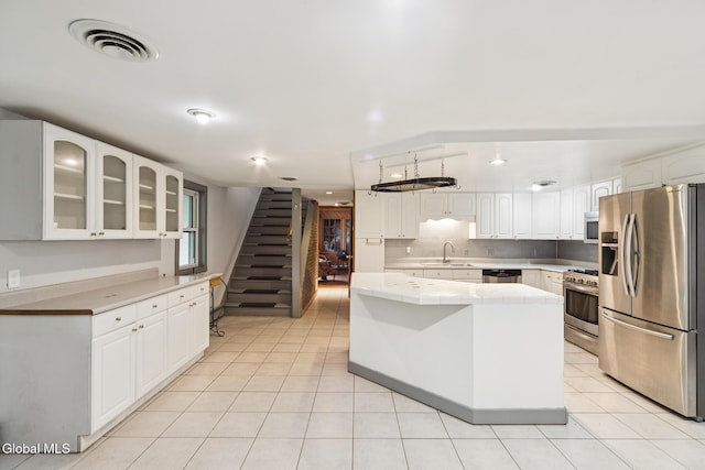 420 Caverns Rd, Cobleskill, NY 12092 - kitchen with appliances with stainless steel finishes, light tile patterned flooring, glass insert cabinets, and white cabinetry