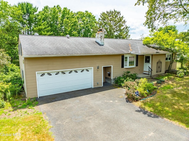 19 Drawbridge Dr, Guilderland, NY 12203 - view of front of house with asphalt driveway, a chimney, and an attached garage