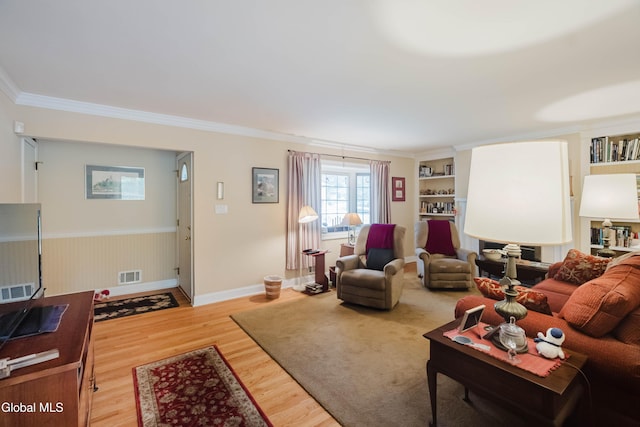 19 Drawbridge Dr, Guilderland, NY 12203 - living room featuring wood finished floors, ornamental molding, wainscoting, and built in features