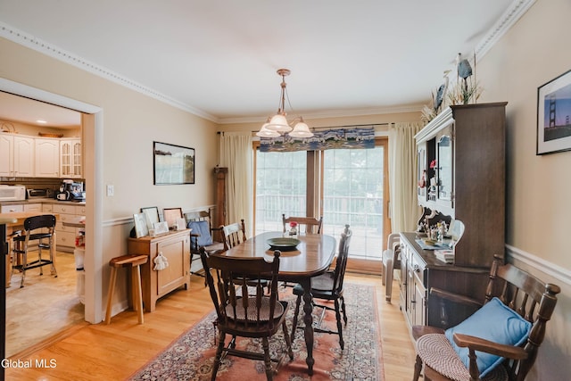 19 Drawbridge Dr, Guilderland, NY 12203 - dining space with a chandelier, light wood-type flooring, and ornamental molding