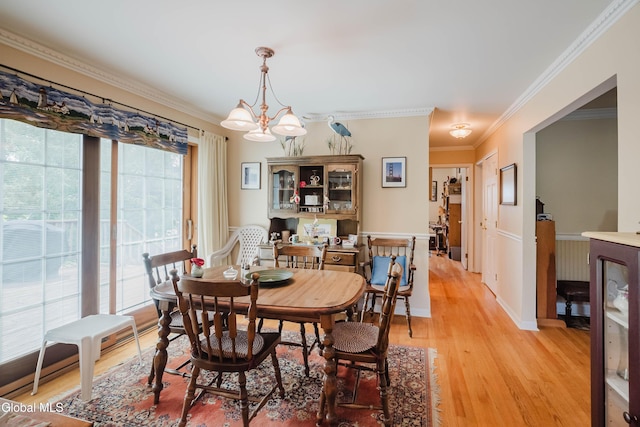 19 Drawbridge Dr, Guilderland, NY 12203 - dining space featuring light wood-style floors, a chandelier, and ornamental molding