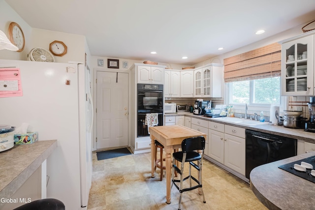 19 Drawbridge Dr, Guilderland, NY 12203 - kitchen with black appliances, white cabinets, glass insert cabinets, and recessed lighting