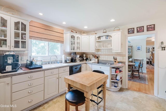 19 Drawbridge Dr, Guilderland, NY 12203 - kitchen featuring black dishwasher, white cabinets, backsplash, glass insert cabinets, and recessed lighting