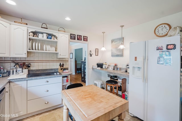19 Drawbridge Dr, Guilderland, NY 12203 - kitchen featuring white refrigerator with ice dispenser, black electric stovetop, white cabinetry, backsplash, and decorative light fixtures