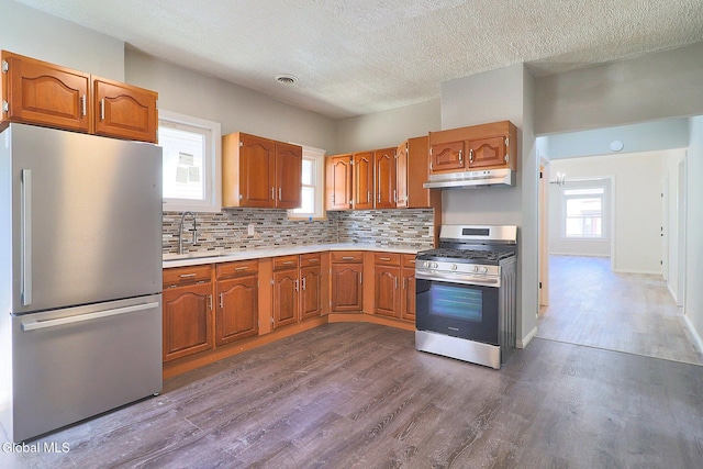 421 Summit Ave, Schenectady, NY 12307 - kitchen with stainless steel appliances, dark wood finished floors, light countertops, brown cabinetry, and a textured ceiling