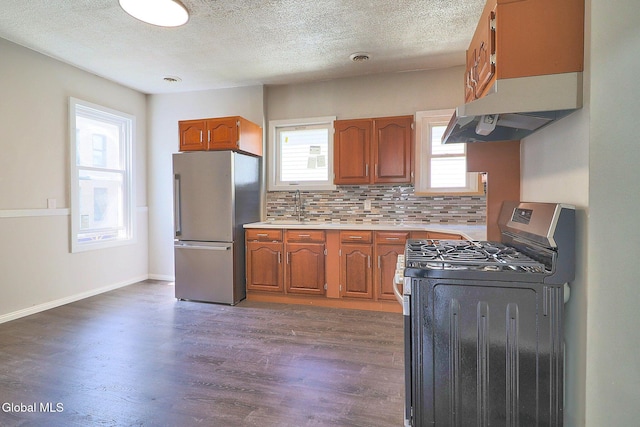 421 Summit Ave, Schenectady, NY 12307 - kitchen featuring stainless steel appliances, brown cabinets, under cabinet range hood, wood finished floors, and a textured ceiling