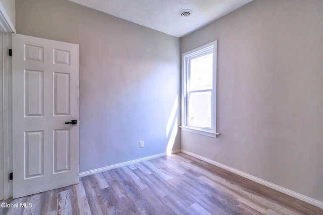 421 Summit Ave, Schenectady, NY 12307 - empty room with wood finished floors and a textured ceiling