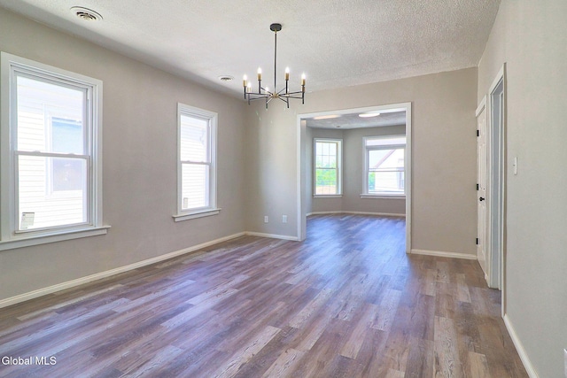 421 Summit Ave, Schenectady, NY 12307 - unfurnished room featuring wood finished floors, a chandelier, and a textured ceiling