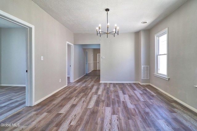 421 Summit Ave, Schenectady, NY 12307 - empty room featuring wood finished floors, a chandelier, and a textured ceiling