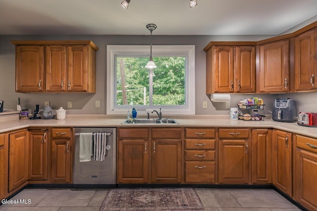 54 S Whitney Rd, Stillwater, NY 12866 - kitchen featuring stainless steel dishwasher, light tile patterned floors, brown cabinets, hanging light fixtures, and light countertops