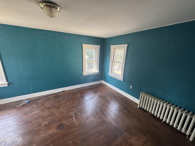 261 Altamont Ave, Schenectady, NY 12304 - unfurnished room featuring radiator heating unit and wood finished floors