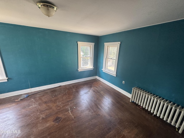 261 Altamont Ave, Schenectady, NY 12304 - spare room with radiator heating unit and wood finished floors