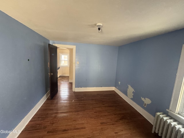 261 Altamont Ave, Schenectady, NY 12304 - unfurnished room featuring radiator and wood finished floors