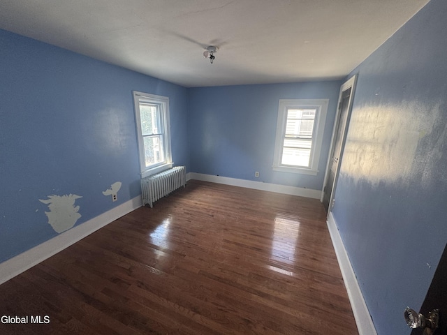 261 Altamont Ave, Schenectady, NY 12304 - empty room with plenty of natural light, radiator heating unit, and wood finished floors