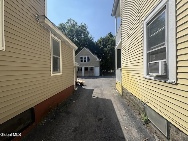 261 Altamont Ave, Schenectady, NY 12304 - view of side of home with a detached garage, an outbuilding, and driveway