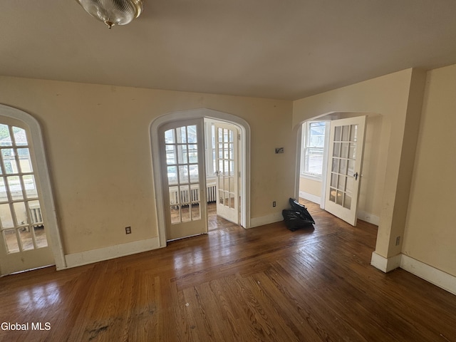 261 Altamont Ave, Schenectady, NY 12304 - spare room featuring arched walkways, plenty of natural light, french doors, and wood finished floors