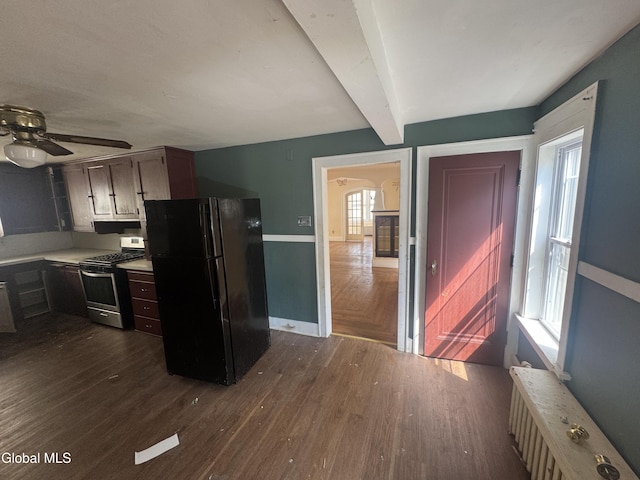 261 Altamont Ave, Schenectady, NY 12304 - kitchen with freestanding refrigerator, dark wood-style floors, radiator, stainless steel gas stove, and light countertops