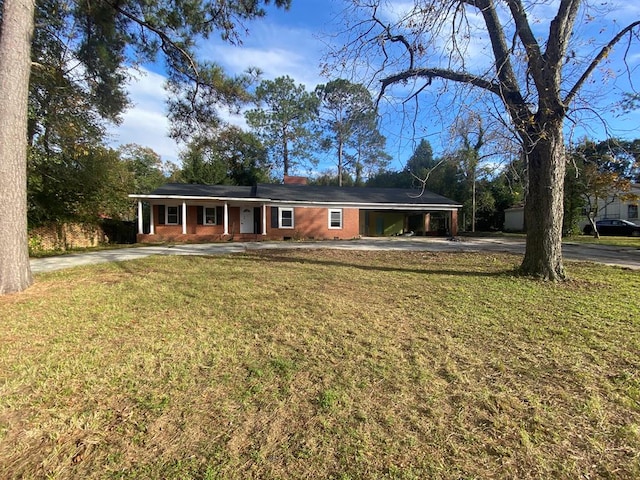 ranch-style home featuring a front yard and a carport