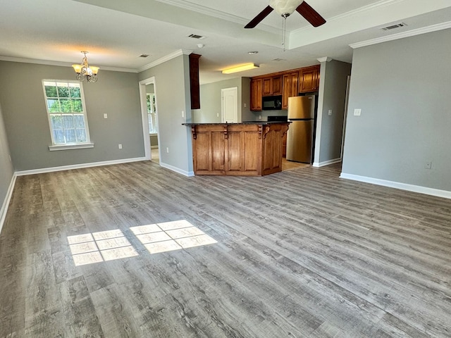 5341 Branch Pt, Valdosta, GA 31605 - kitchen featuring freestanding refrigerator, black microwave, open floor plan, light wood-style floors, and crown molding