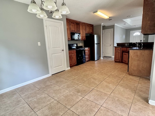 5341 Branch Pt, Valdosta, GA 31605 - kitchen with black appliances, dark countertops, ornamental molding, light tile patterned flooring, and hanging light fixtures