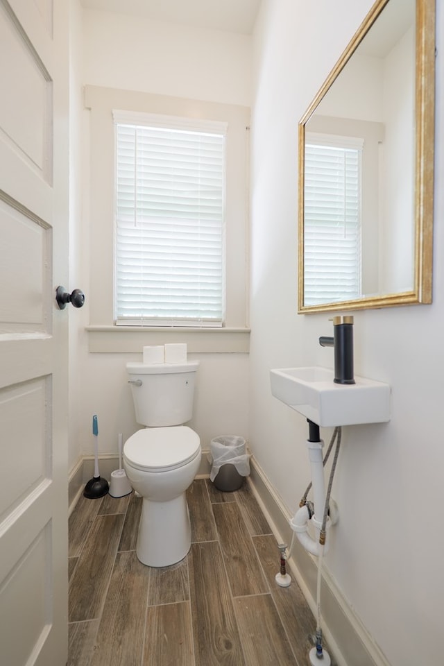 1611 N Patterson St, Valdosta, GA 31602 - half bathroom with wood finished floors and toilet
