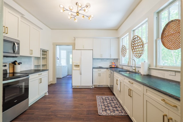 1611 N Patterson St, Valdosta, GA 31602 - kitchen with stainless steel appliances, plenty of natural light, dark wood-style floors, and a chandelier